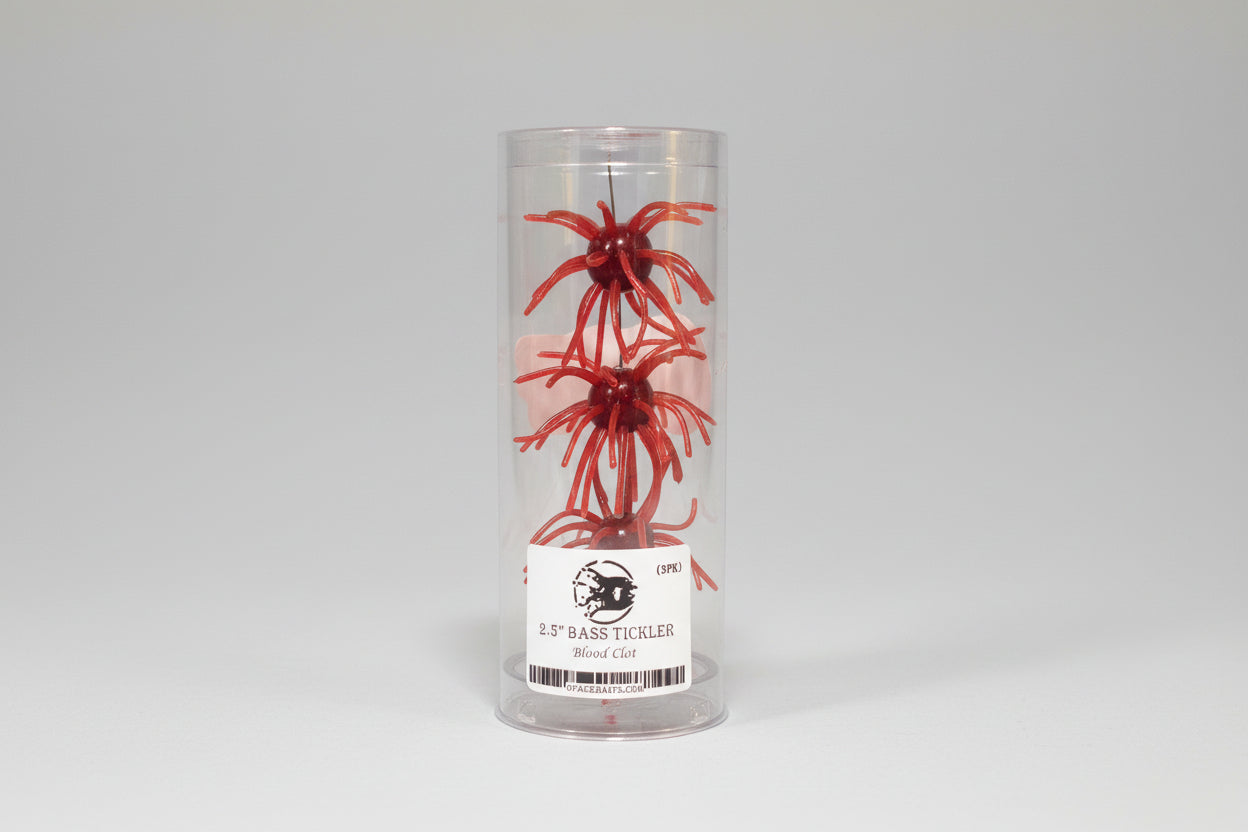 Red fishing lure in a clear container with a label on a professional white background.