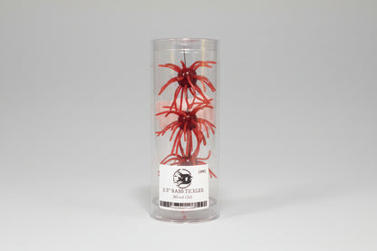 Red fishing lure in a clear container with a label on a professional white background.
